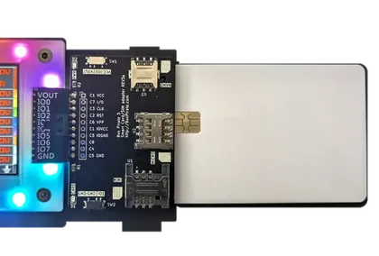 Bus Pirate smartcard and SIM adapter connected through a 10-pin header.