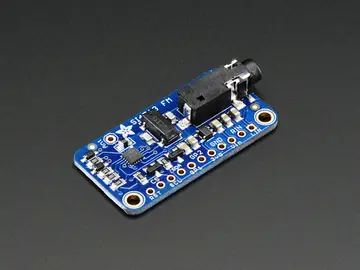 Si4713 FM transmitter front angled module photo showing audio jack, antenna wire, Si4713 chip and labeled edge pads.