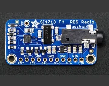 Si4713 FM transmitter module pinout photo showing Vin, GND, 3Vo, RST, CS, SCL, SDA, LIN, RIN, GP1 and GP2 labels.